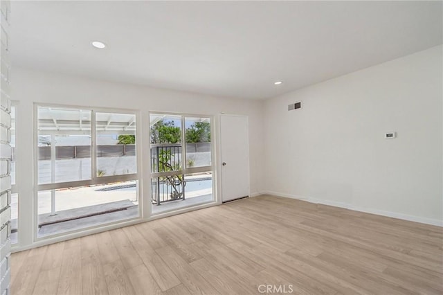 1304 N Devonshire Rd, Anaheim, CA 92801 - unfurnished room with light wood-type flooring, baseboards, and recessed lighting