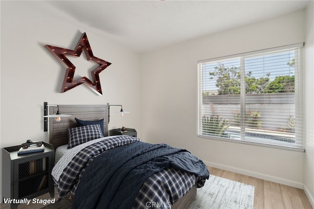 1304 N Devonshire Rd, Anaheim, CA 92801 - bedroom with multiple windows, baseboards, and wood finished floors