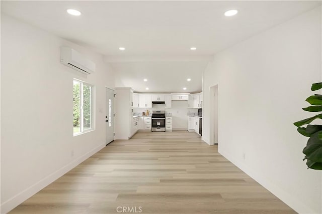 414 Markton St, Los Angeles, CA 90061 - unfurnished living room with an AC wall unit, recessed lighting, baseboards, and light wood-style floors