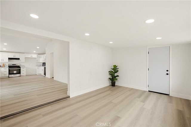 414 Markton St, Los Angeles, CA 90061 - unfurnished living room featuring light wood-type flooring, recessed lighting, and baseboards