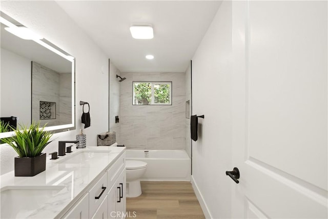 414 Markton St, Los Angeles, CA 90061 - full bathroom with double vanity, wood finished floors, toilet, tub / shower combination, and baseboards