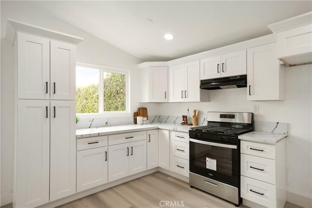 414 Markton St, Los Angeles, CA 90061 - kitchen featuring gas range, under cabinet range hood, light wood-type flooring, white cabinetry, and light stone counters