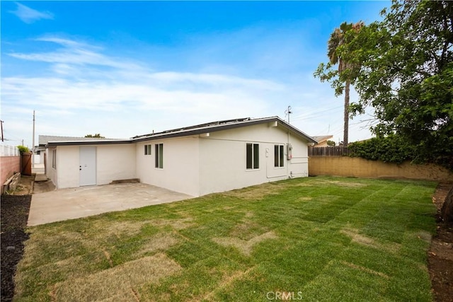 414 Markton St, Los Angeles, CA 90061 - back of house featuring stucco siding, a patio, and solar panels