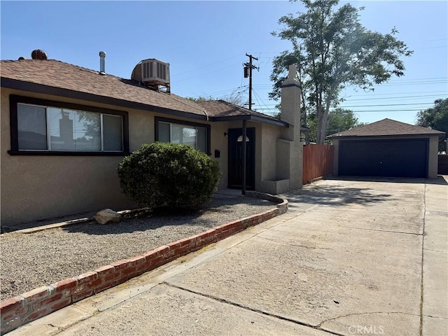 44037 Fern Ave, Lancaster, CA 93534 - ranch-style house with central AC unit, stucco siding, an outbuilding, a detached garage, and a shingled roof
