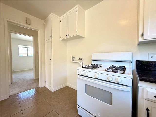 44037 Fern Ave, Lancaster, CA 93534 - kitchen featuring gas range gas stove, white cabinets, baseboards, tile patterned flooring, and dark countertops