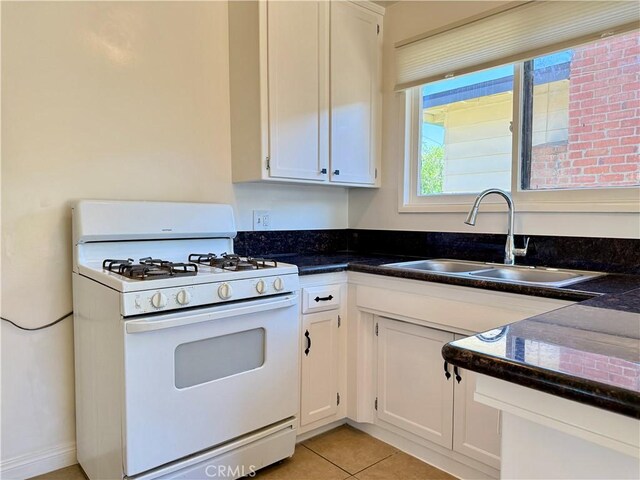 44037 Fern Ave, Lancaster, CA 93534 - kitchen with gas range gas stove, a sink, white cabinetry, and light tile patterned floors