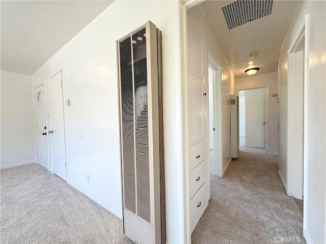44037 Fern Ave, Lancaster, CA 93534 - hallway featuring a heating unit, light carpet, and baseboards
