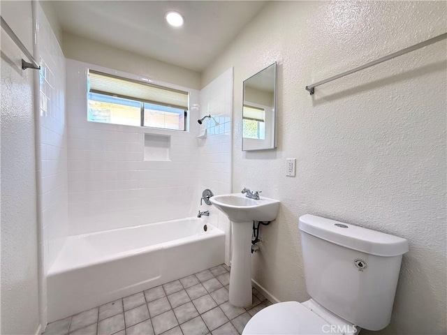 44037 Fern Ave, Lancaster, CA 93534 - full bath featuring toilet, tile patterned floors,  shower combination, and a textured wall