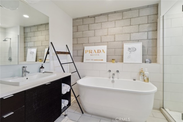 3450 Cahuenga Blvd W Unit 905, Los Angeles, CA 90068 - full bathroom with vanity, a soaking tub, tile patterned flooring, tile walls, and a tile shower