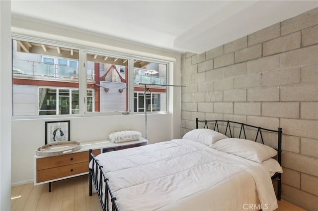 3450 Cahuenga Blvd W Unit 905, Los Angeles, CA 90068 - bedroom featuring wood finished floors, concrete block wall, and baseboards