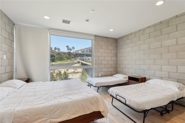 3450 Cahuenga Blvd W Unit 905, Los Angeles, CA 90068 - bedroom with wood finished floors, tile walls, and recessed lighting