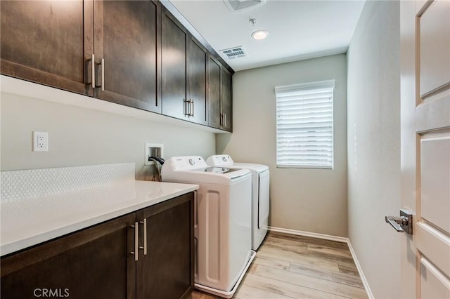 13139 Upland Ct, Hesperia, CA 92344 - laundry room featuring cabinet space, separate washer and dryer, light wood-type flooring, and baseboards