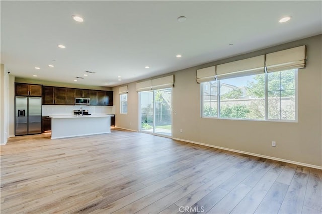 13139 Upland Ct, Hesperia, CA 92344 - unfurnished living room featuring baseboards, light wood-style flooring, and recessed lighting
