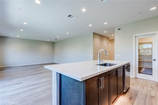 13139 Upland Ct, Hesperia, CA 92344 - kitchen with a sink, light wood-style flooring, an island with sink, light countertops, and recessed lighting