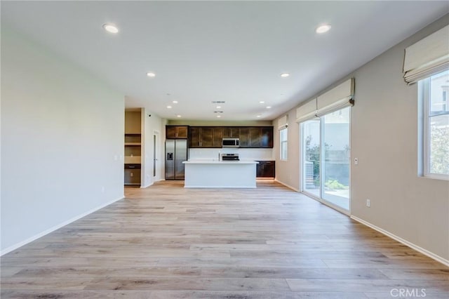 13139 Upland Ct, Hesperia, CA 92344 - kitchen with appliances with stainless steel finishes, open floor plan, dark brown cabinets, healthy amount of natural light, and recessed lighting