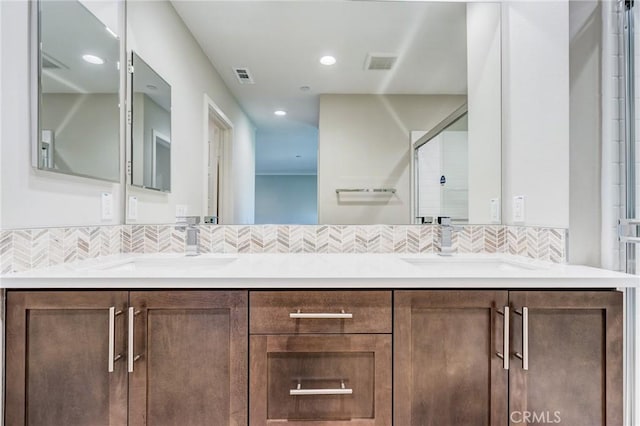 13139 Upland Ct, Hesperia, CA 92344 - bathroom featuring double vanity, tasteful backsplash, recessed lighting, and a shower with shower door