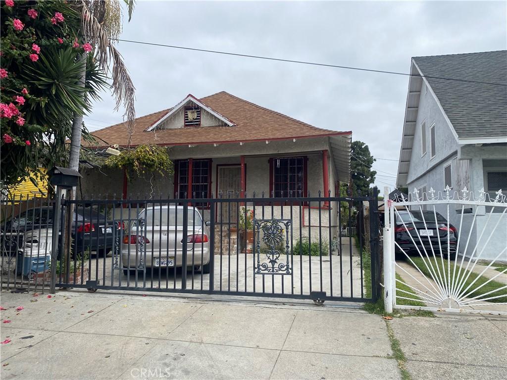 317 E 42nd Pl, Los Angeles, CA 90011 - bungalow-style house featuring a gate, a shingled roof, stucco siding, and covered porch