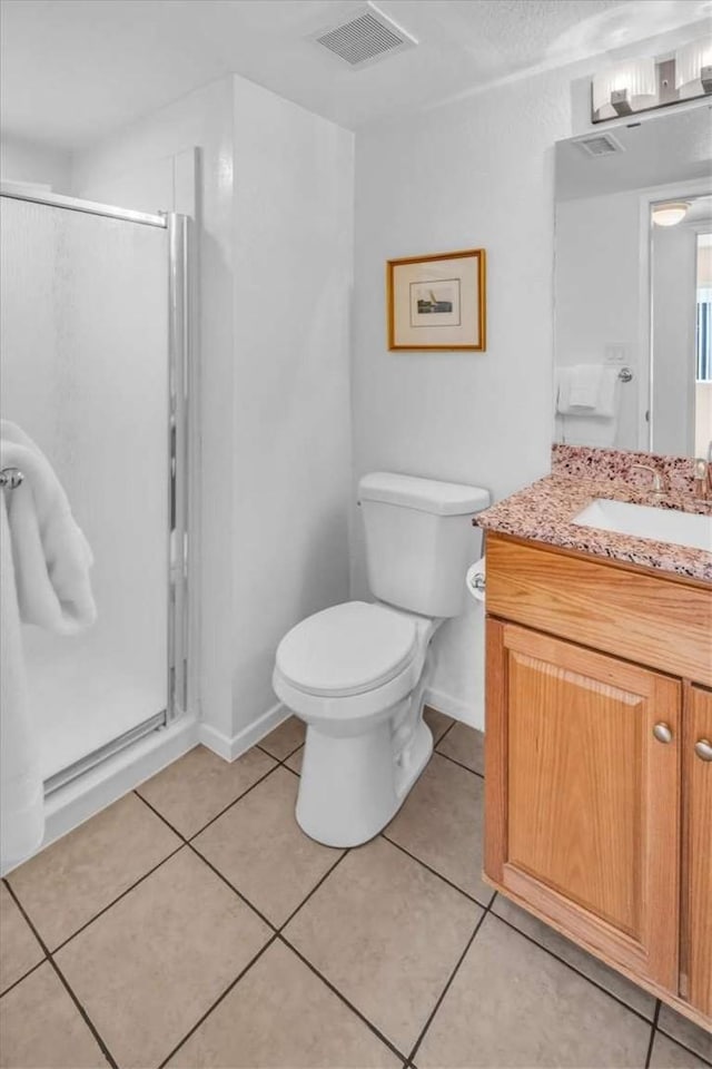 1582 Lisa Ln, Redlands, CA 92374 - bathroom with vanity, a stall shower, toilet, and tile patterned floors