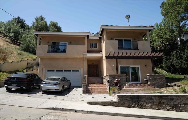1630 Bridgeport Dr, Los Angeles, CA 90065 - view of front of property featuring a balcony, stucco siding, driveway, and a garage