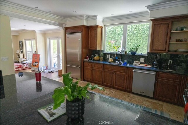 1630 Bridgeport Dr, Los Angeles, CA 90065 - kitchen featuring appliances with stainless steel finishes, decorative backsplash, a sink, dark stone countertops, and crown molding