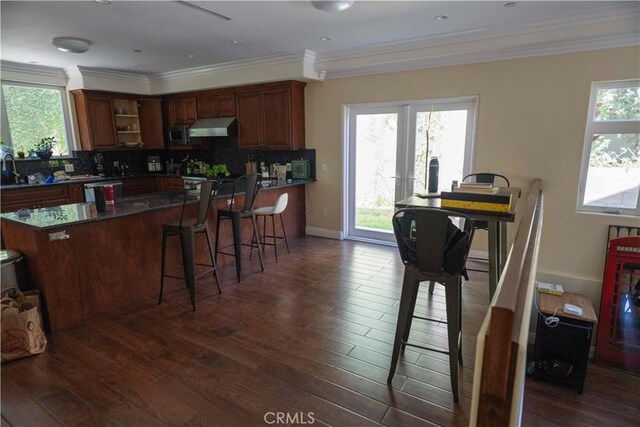 1630 Bridgeport Dr, Los Angeles, CA 90065 - kitchen with exhaust hood, dark wood-style floors, dark countertops, plenty of natural light, and ornamental molding