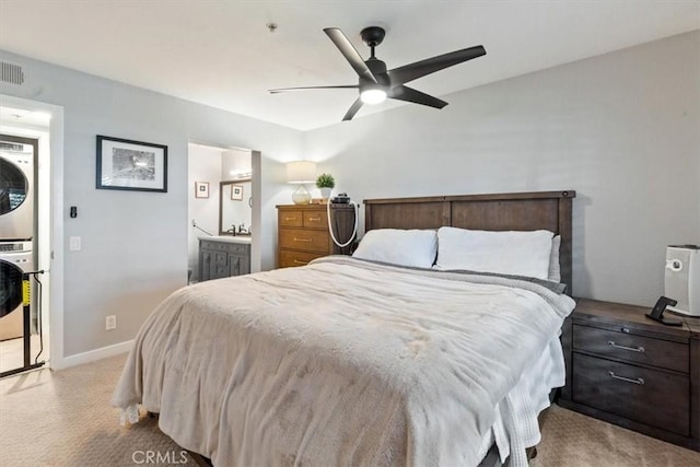 236 S Grisly Canyon Dr Unit N, Orange, CA 92869 - bedroom with stacked washer / dryer, light carpet, baseboards, ceiling fan, and ensuite bath