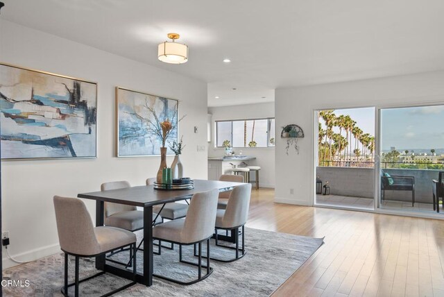 7560 Hollywood Blvd Unit 409, Los Angeles, CA 90046 - dining area with baseboards, recessed lighting, and light wood-type flooring