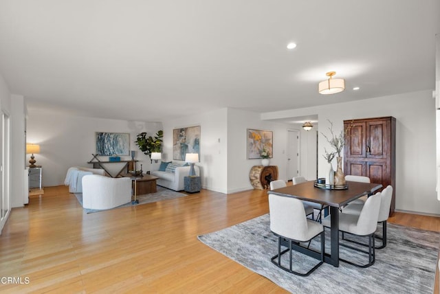 7560 Hollywood Blvd Unit 409, Los Angeles, CA 90046 - dining space featuring recessed lighting, light wood-style flooring, and baseboards