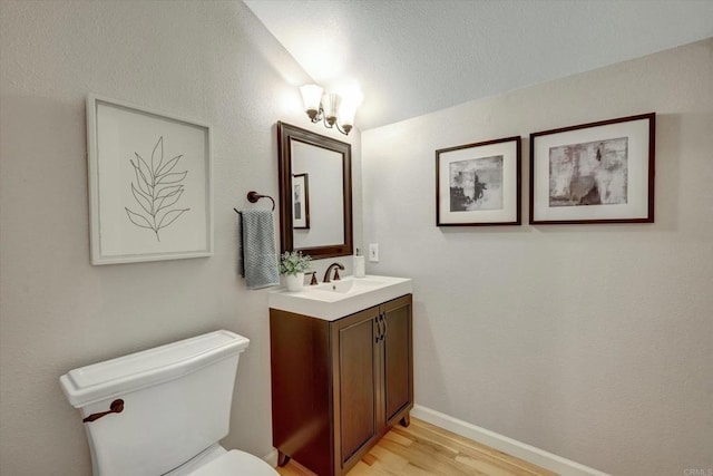 4523 Cordoba Way, Oceanside, CA 92056 - bathroom featuring vanity, toilet, wood finished floors, and baseboards