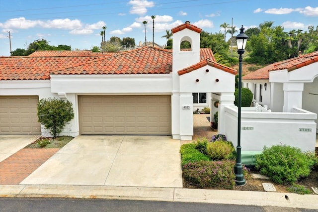 4523 Cordoba Way, Oceanside, CA 92056 - mediterranean / spanish house featuring a tiled roof, concrete driveway, stucco siding, and an attached garage