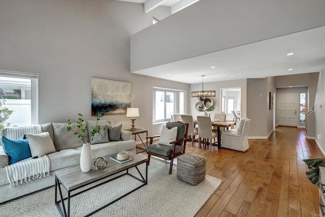 4523 Cordoba Way, Oceanside, CA 92056 - living area featuring light wood finished floors, a chandelier, baseboards, recessed lighting, and a high ceiling