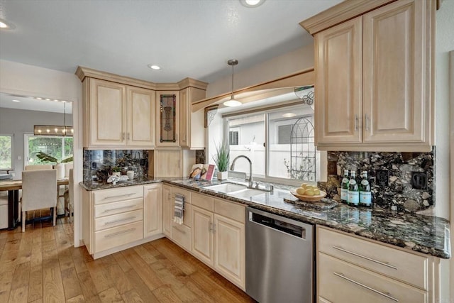 4523 Cordoba Way, Oceanside, CA 92056 - kitchen with dishwasher, light wood finished floors, decorative backsplash, dark stone countertops, and light brown cabinetry