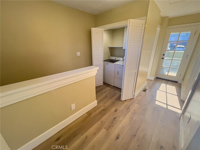 881 Peach St Unit A, San Luis Obispo, CA 93401 - hallway featuring washer and dryer, light wood-style flooring, and baseboards