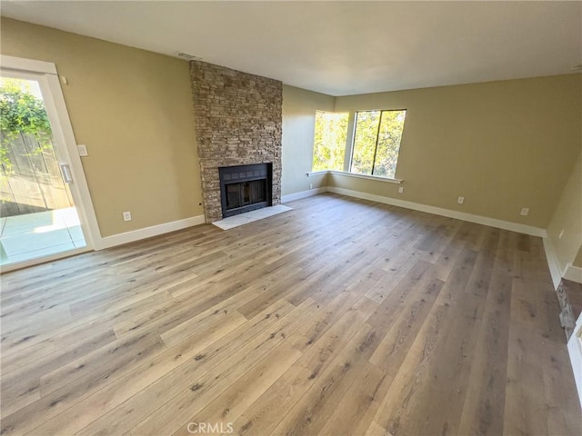 881 Peach St Unit A, San Luis Obispo, CA 93401 - unfurnished living room featuring hardwood / wood-style flooring, a fireplace, and baseboards