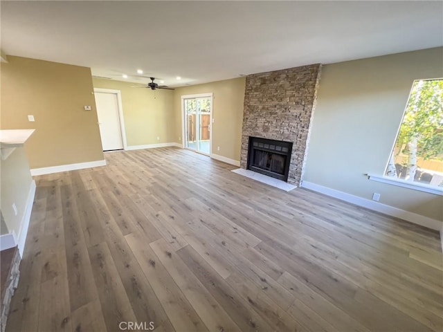881 Peach St Unit A, San Luis Obispo, CA 93401 - unfurnished living room with a stone fireplace, hardwood / wood-style floors, recessed lighting, baseboards, and ceiling fan