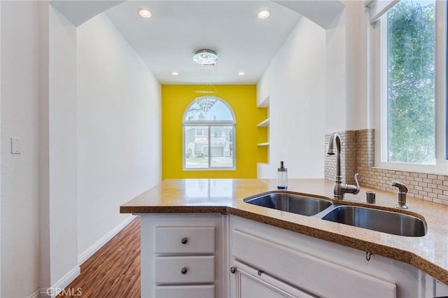 11259 Corsica Ct, Rancho Cucamonga, CA 91730 - kitchen featuring light stone counters, white cabinetry, wood finished floors, recessed lighting, and a peninsula