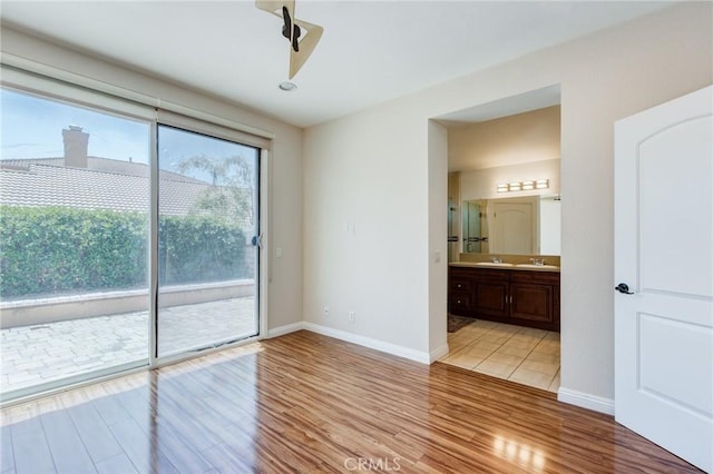 11259 Corsica Ct, Rancho Cucamonga, CA 91730 - unfurnished bedroom with access to exterior, light wood-type flooring, and ensuite bath