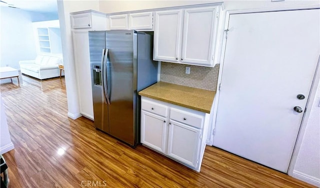 11259 Corsica Ct, Rancho Cucamonga, CA 91730 - kitchen with stainless steel fridge, wood finished floors, tasteful backsplash, and white cabinetry