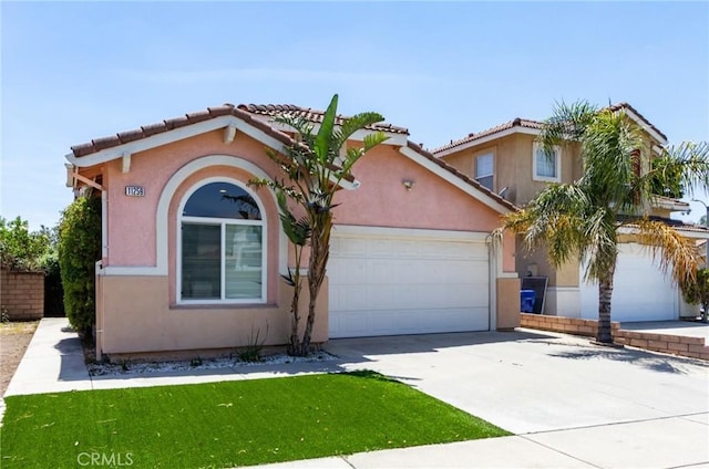 11259 Corsica Ct, Rancho Cucamonga, CA 91730 - mediterranean / spanish-style house with an attached garage, concrete driveway, stucco siding, and a front lawn