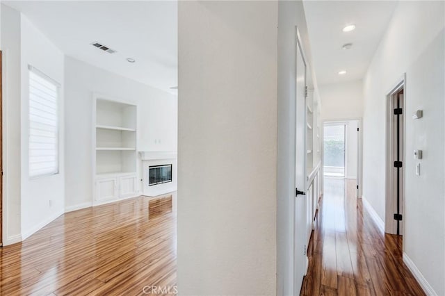 11259 Corsica Ct, Rancho Cucamonga, CA 91730 - hall with built in shelves, wood finished floors, and recessed lighting