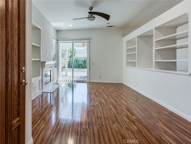 11259 Corsica Ct, Rancho Cucamonga, CA 91730 - unfurnished living room featuring a ceiling fan, dark wood-style floors, built in features, a glass covered fireplace, and recessed lighting