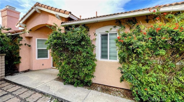 11259 Corsica Ct, Rancho Cucamonga, CA 91730 - entrance to property with stucco siding, a patio, and a tile roof