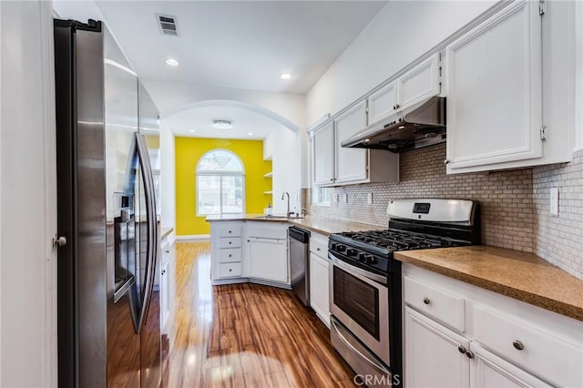 11259 Corsica Ct, Rancho Cucamonga, CA 91730 - kitchen with appliances with stainless steel finishes, under cabinet range hood, a peninsula, wood finished floors, and white cabinets