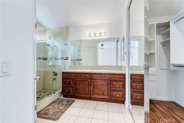 11259 Corsica Ct, Rancho Cucamonga, CA 91730 - bathroom featuring a stall shower, double vanity, and tile patterned floors