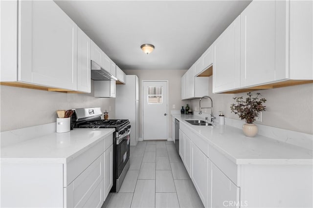38881 Sage Tree St, Palmdale, CA 93551 - kitchen featuring appliances with stainless steel finishes, a sink, white cabinets, and wall chimney exhaust hood