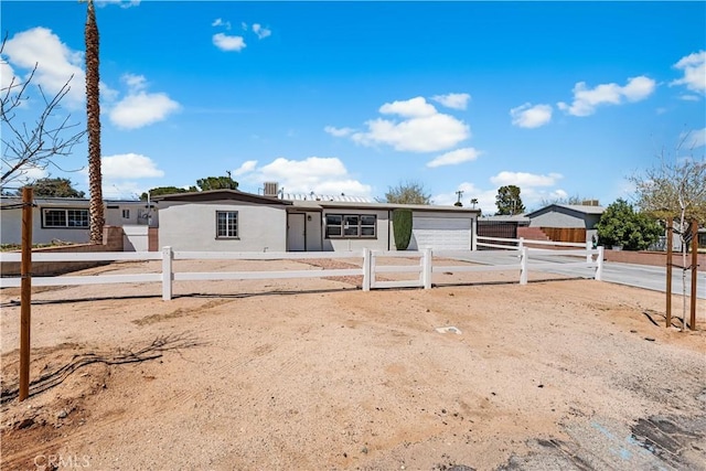 38881 Sage Tree St, Palmdale, CA 93551 - view of front of house featuring a garage, a fenced front yard, and concrete driveway