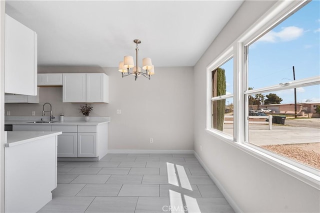 38881 Sage Tree St, Palmdale, CA 93551 - kitchen with a sink, baseboards, a chandelier, light countertops, and pendant lighting