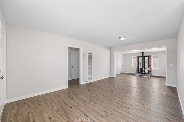 38881 Sage Tree St, Palmdale, CA 93551 - unfurnished living room featuring a heating unit, wood finished floors, and baseboards