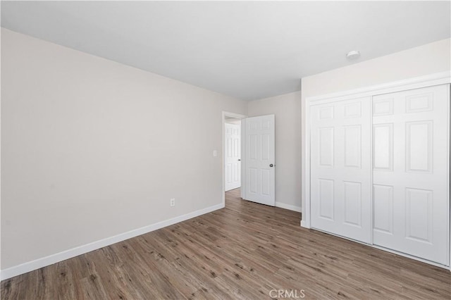 38881 Sage Tree St, Palmdale, CA 93551 - unfurnished bedroom with baseboards, wood finished floors, and a closet
