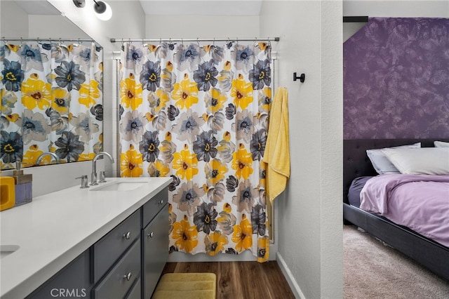 13797 Mesquite Dr, Fontana, CA 92337 - bathroom with wood finished floors, double vanity, a shower with shower curtain, baseboards, and connected bathroom